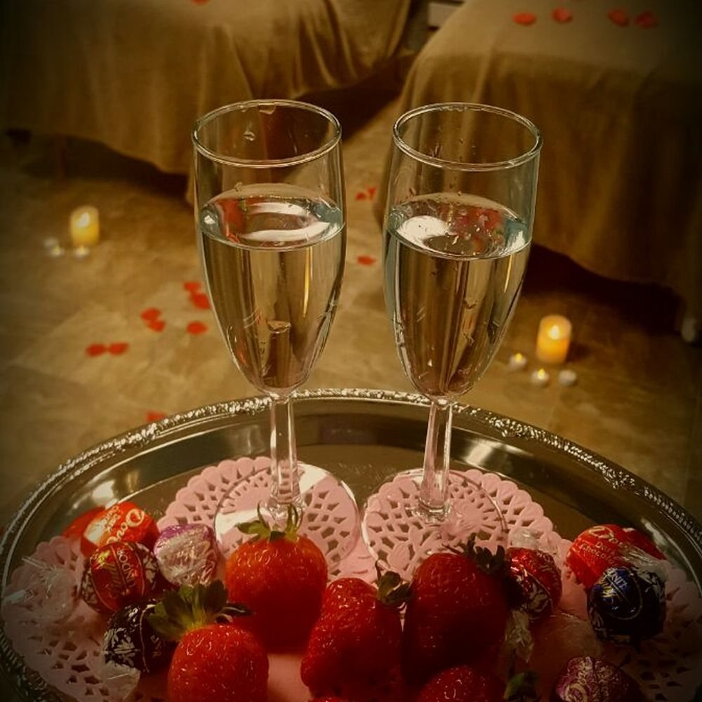 Champagne, strawberries and rose petals prepared for a couple at TerraLux SPA in Chișinău